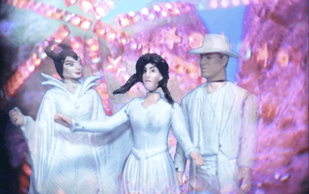 Three plastic characters are all dressed in white in front of a bright pink and blue swirling background. One character is wearing a headpiece with sharp horns, another is wearing a white cowboy hat.